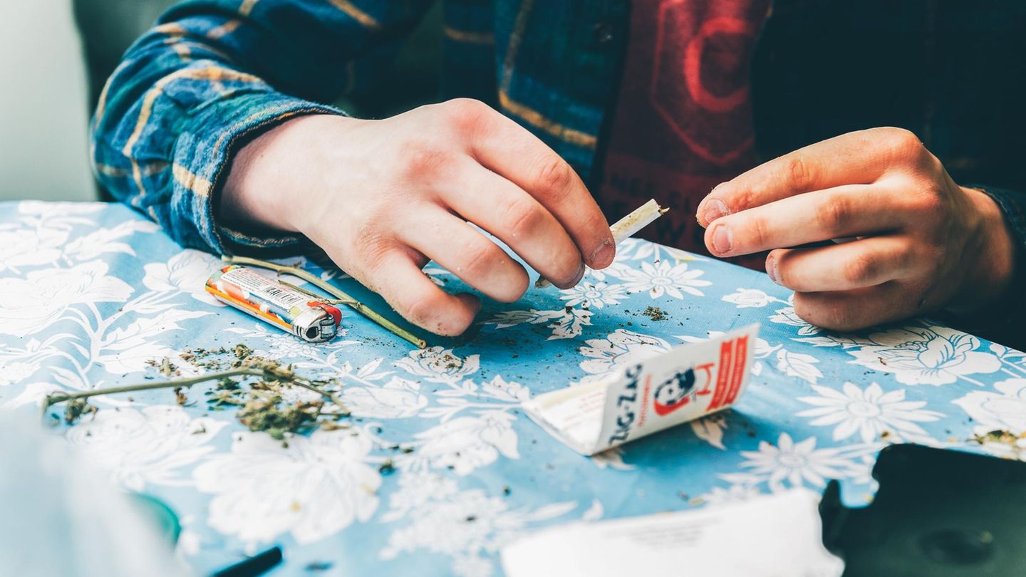 Ein junger Mann dreht sich einen Joint