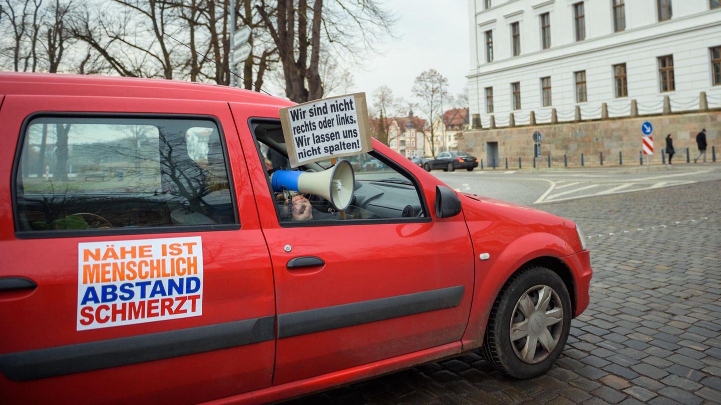 Ein Fahrzeug mit Plakaten, auf denen Slogans gegen den Lockdown stehen