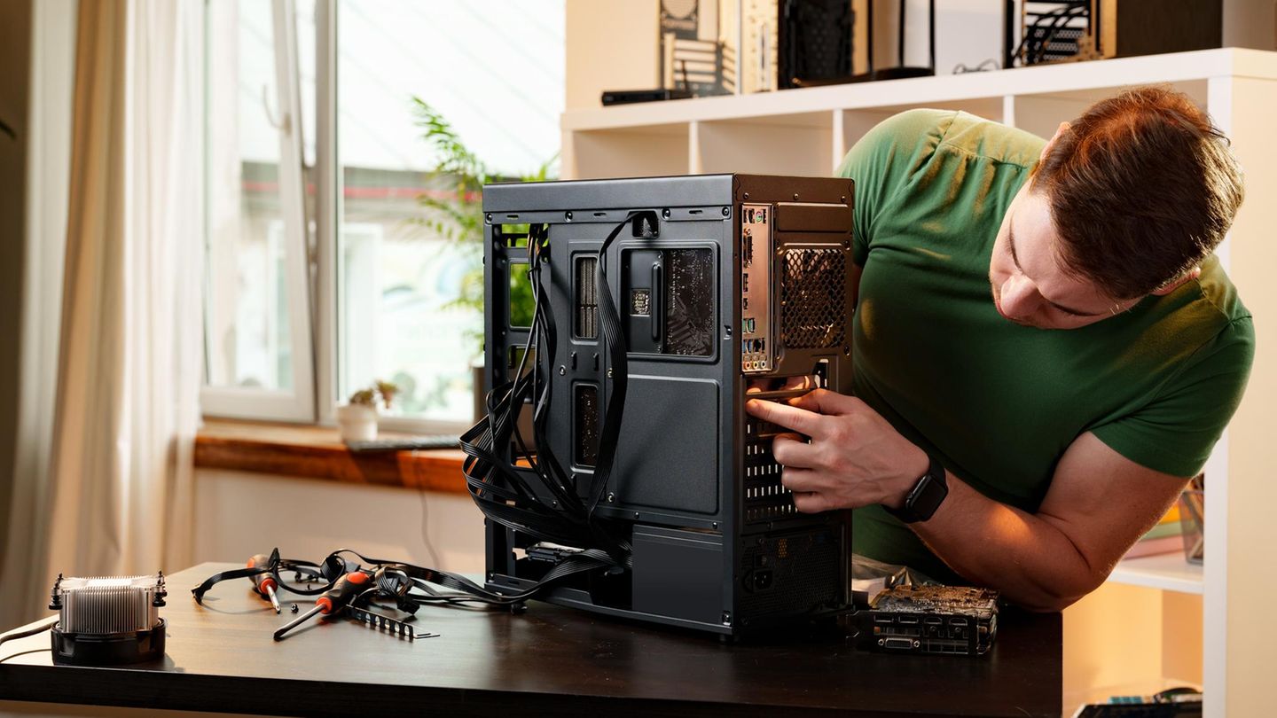 Mann montiert zu Hause eine Computersystemeinheit