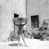 Ein Model hält einen riesigen Sonnenhut über ihrem Kopf