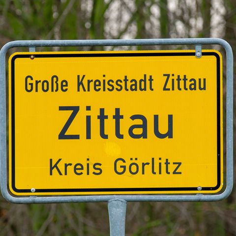 Auf einem gelben Ortsschild steht "Große Kreisstadt Zittau. Kreis Görlitz"