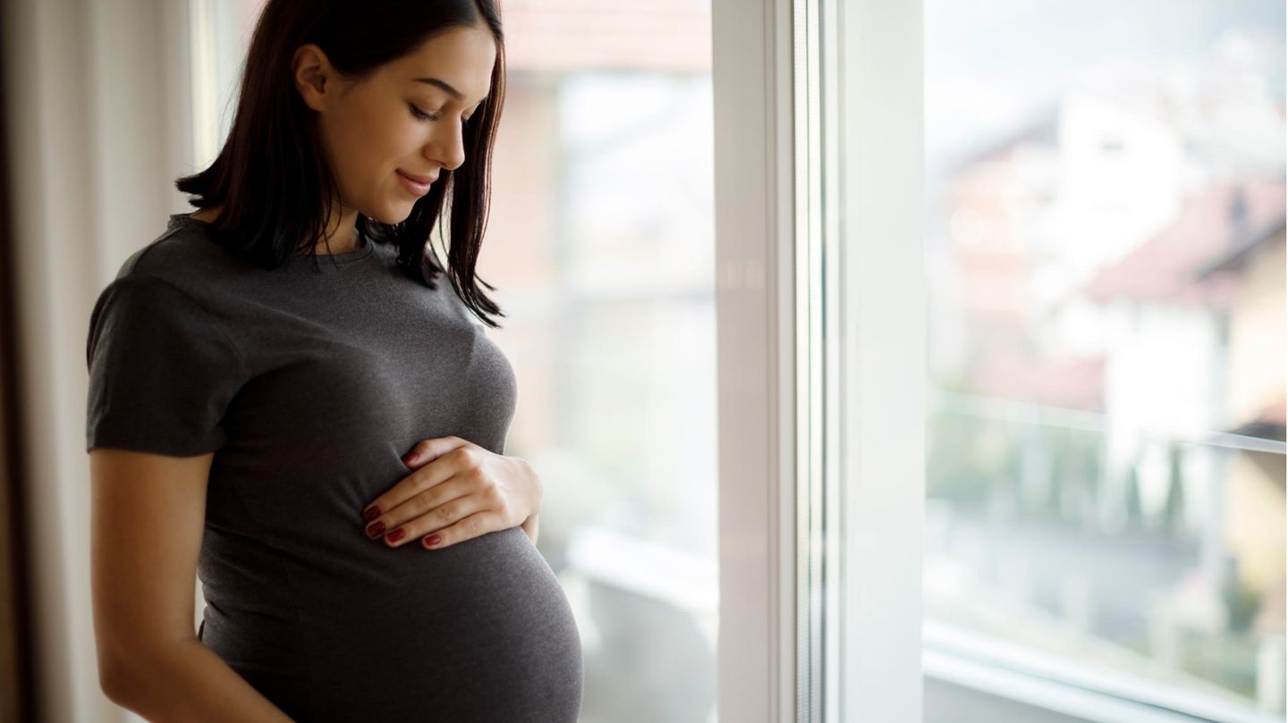 Schwangere Frau hält ihren Bauch
