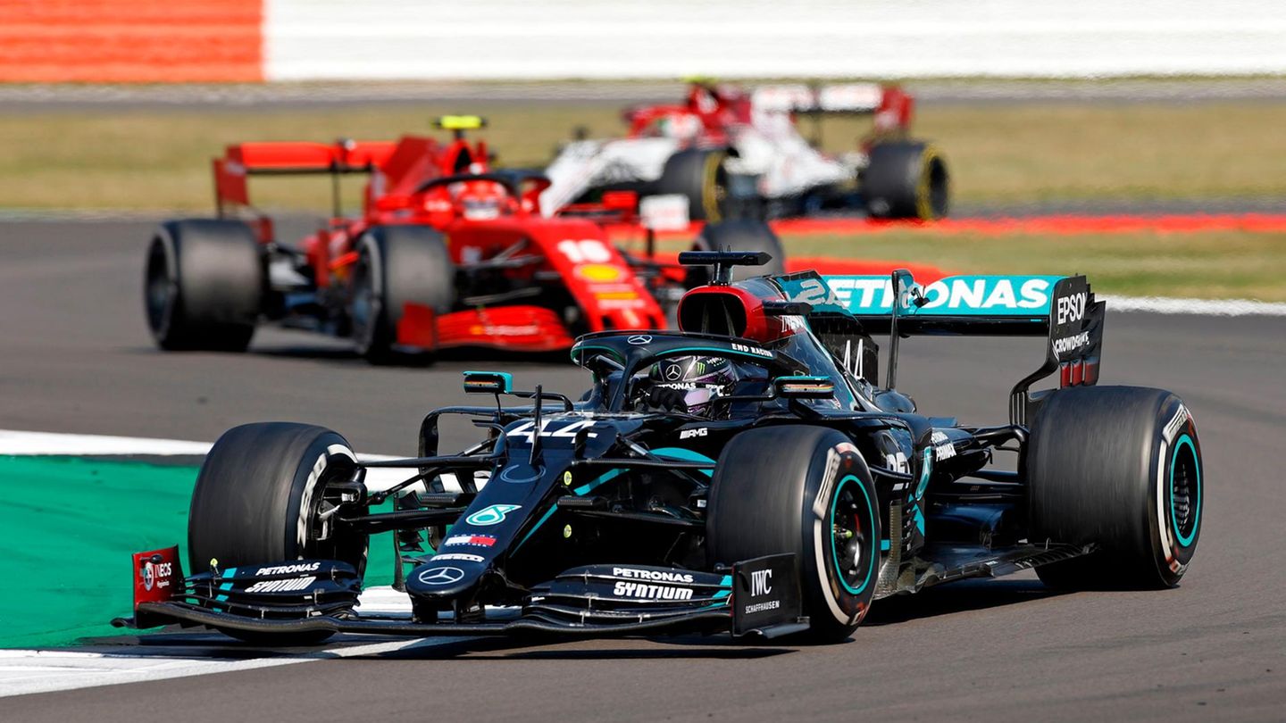 Lewis Hamilton in the Mercedes driving at Silverstone ahead of the Ferrari of Charles Leclerc