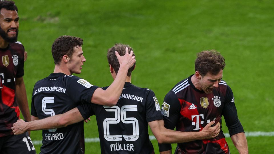Vier Spieler des FC Bayern München jubeln auf dem Rasen des Bundesliga-Stadions in Leipzig