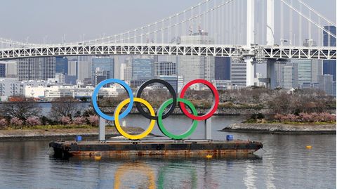 Die Ringe der Olympischen Spiele stehen vor dem Regenbogenbrücke im Odaiba Marine Park in Tokio