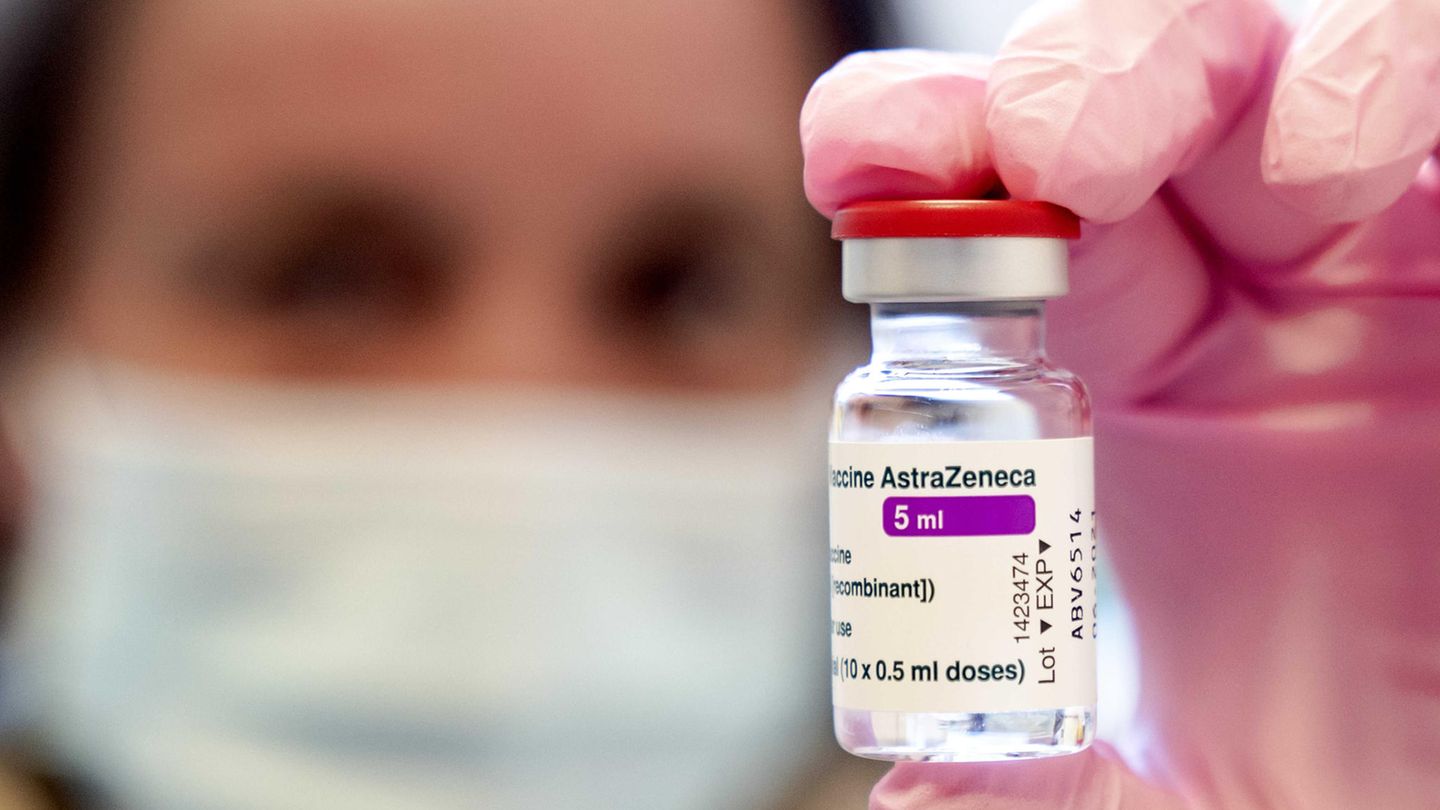 Eine Person hält eine Ampulle des Impfstoffs von Astrazeneca in die Kamera.