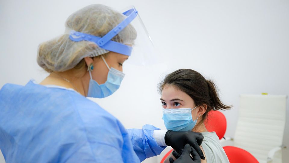 Einigung der Gesundheitsminister: Jüngere Astrazeneca-Geimpfte sollen auf anderes Präparat umsteigen Eine Frau bekommt in einem Impfzentrum eine Spritze mit dem Impfstoff von AstraZeneca