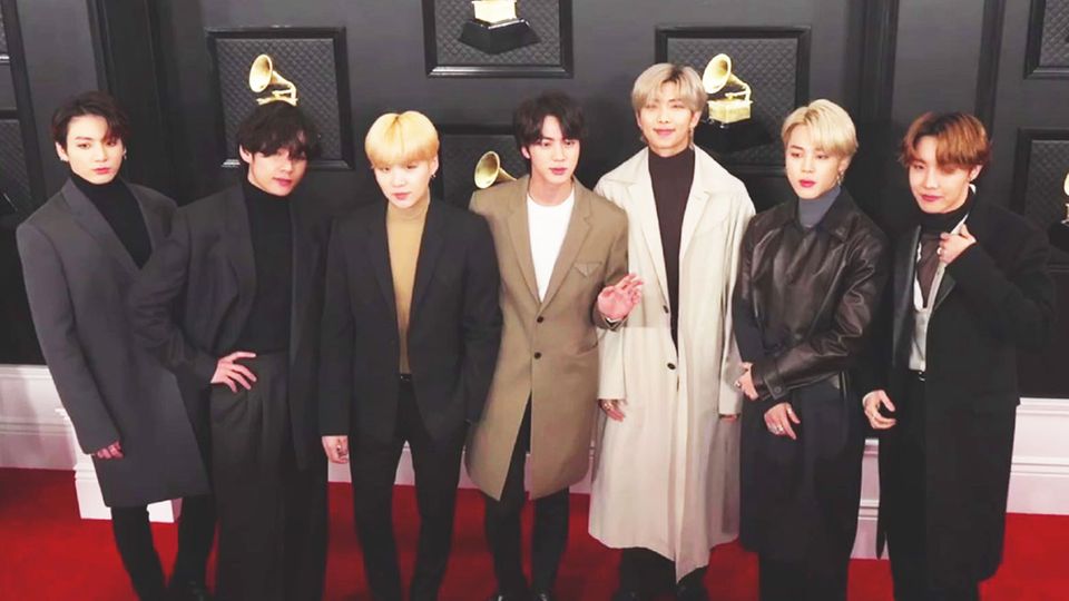 K-pop group poses for a photo on the red carpet