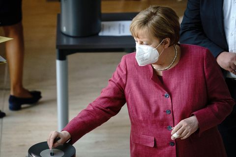Bundeskanzlerin Angela Merkel (CDU) steckt ihre Stimmkarte bei der Sitzung des Bundestags in die Wahlurne