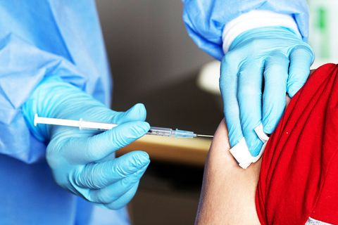 Patient bekommt Impfung in den Arm verabreicht