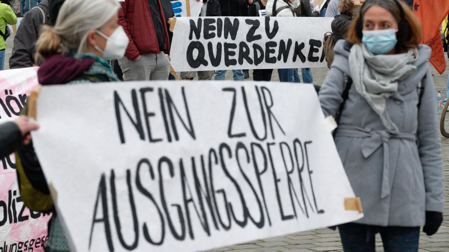 Demonstranten mit einem Banner mit der Aufschrift "Nein zur Ausgangssperre"