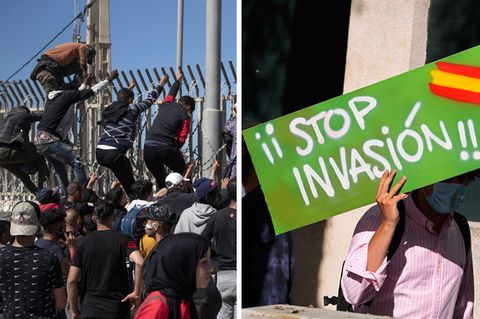 Migranten klettern über Grenzzaun