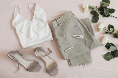 Lingerie-Top und Jeans liegen drapiert auf dem Boden