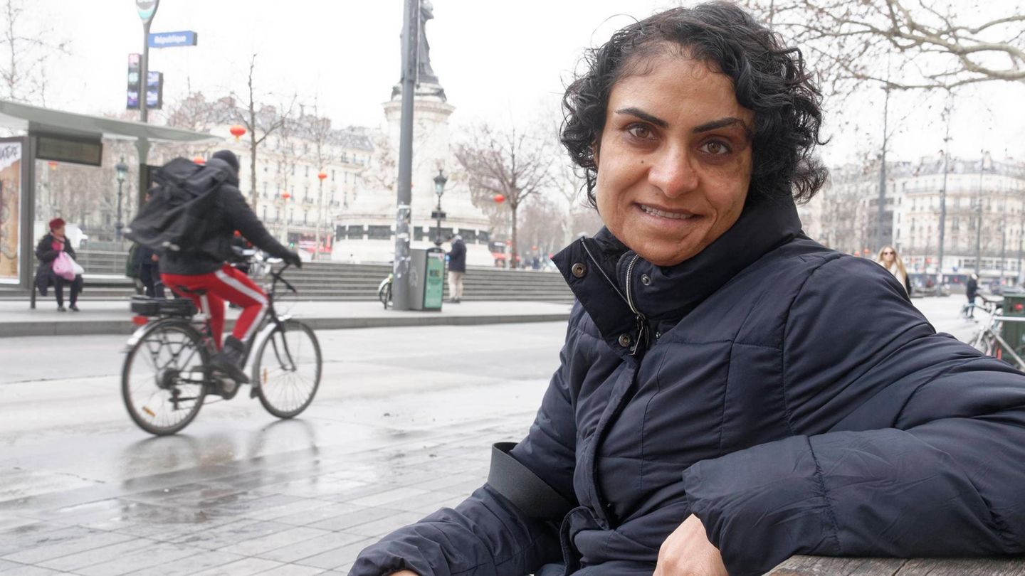 Nadia Ghulam sitzt mit einem Buch in der Hand auf einer Parkbank