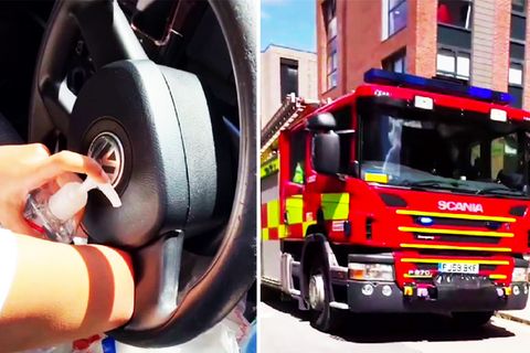 Junge Frau steckt mit Arm in einem Auto-Lenkrad fest