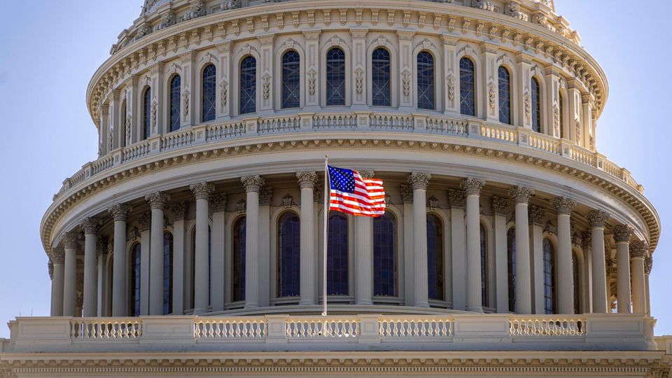 An American woman flatters the Capitol in Washington in the Wind