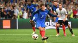 Antoine Griezmann bläst die Wangen zusammen während er den Ball schießt