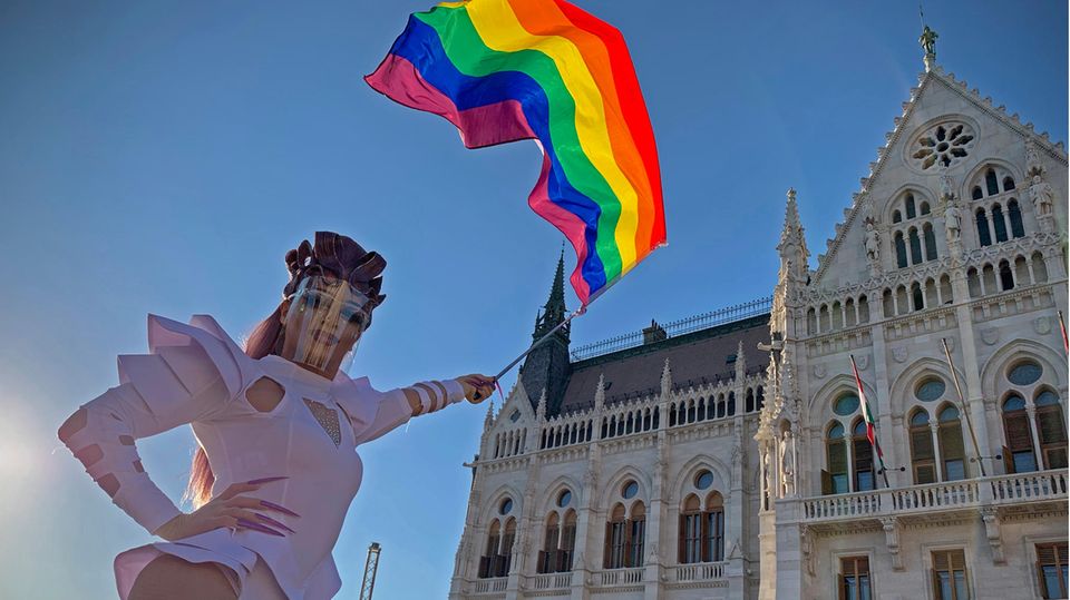 Eine Drag Queen schwenkt eine Regenbogenfahne auf einer LGBT-Rechte-Demonstration vor dem ungarischen Parlament