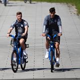 Die deutschen Nationalspieler Bernd Leno (l.), Timo Werner und Kai Havertz (r.) radeln entspannt zum Trainingsgelände im "Home Ground", direkt bei der Adidas-Zentrale