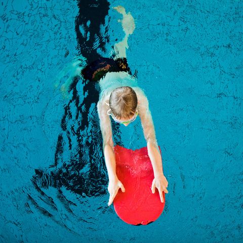 A boy takes part in a swimming course for children