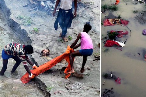 In Indien legt der Monsunregen die provisorischen Gräber am Ufer des Ganges frei