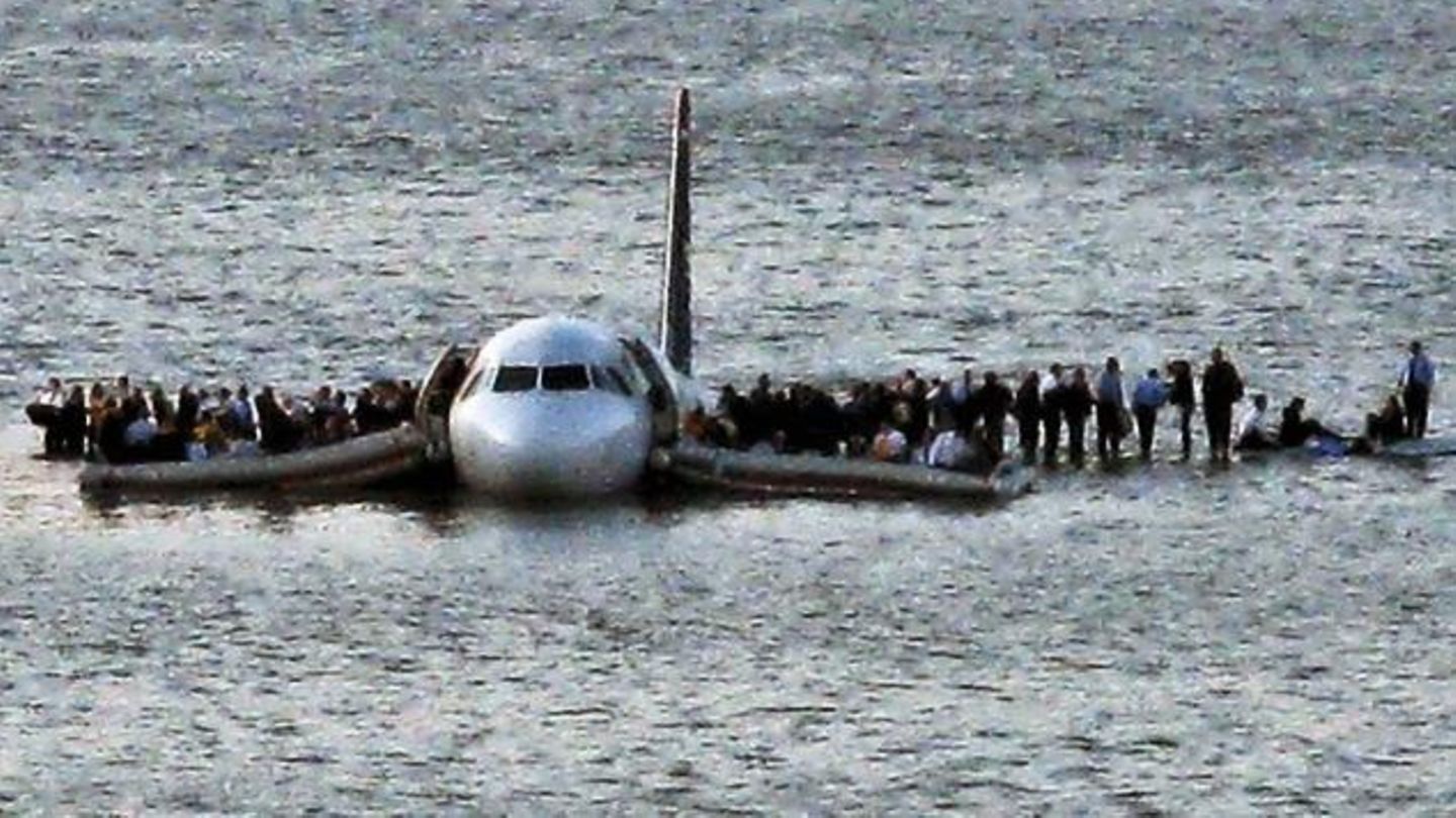 Airline passengers wait to board a ferry to be rescued on the wings of a US Airways Airbus 320 jetliner that safely ditched in the frigid waters of the Hudson River in New York, Thursday Jan. 15, 2009 after a flock of birds knocked out both its engines....