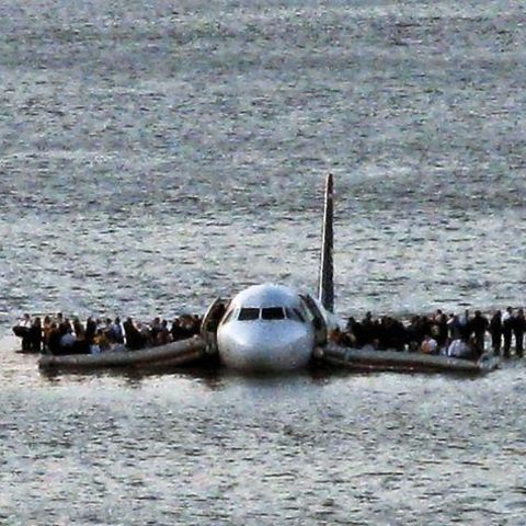 Airline passengers wait to board a ferry to be rescued on the wings of a US Airways Airbus 320 jetliner that safely ditched in the frigid waters of the Hudson River in New York, Thursday Jan. 15, 2009 after a flock of birds knocked out both its engines....