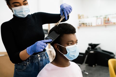 Eine Friseurin beim Schneiden von Afro-Haaren