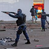 Hier stehen Soldaten in Johannesburg mit Schrotflinten im Anschlag auf der Straße, um mit Plünderungen fertig zu werden.