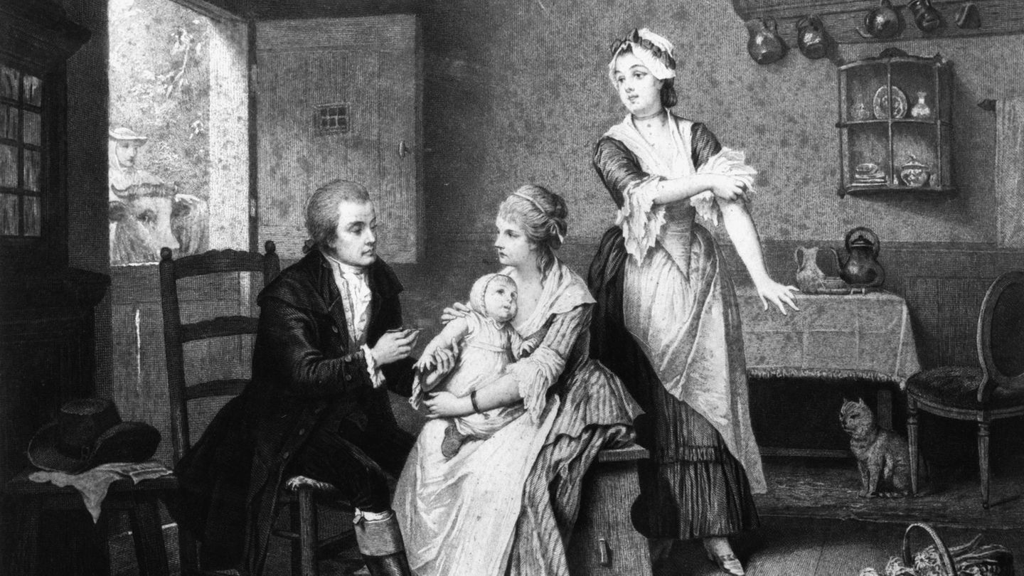 Ein Holzstich nach einem Gemälde von Edouard Hamman zeigt, wie der der englische Landarzt Edward Jenner 1796 bei einem achtjährigen Jungen die erste Impfung gegen Pocken durchführt.