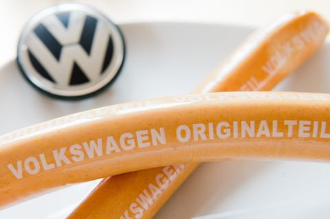 Zwei Currywürste liegen auf einem Teller mit VW-Firmenlogo