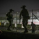 Soldaten am nächtlichen Flughafen