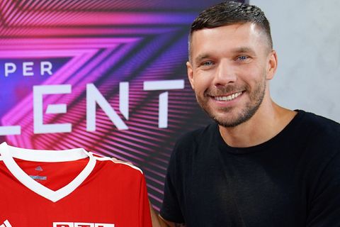 Lukas Podolski lacht beim Fototermin im Juli in die Kamera