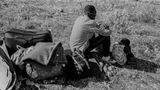 Ein Mann und ein kleines Mädchen mit ihrem Besitz etwas abseits von den Protesten im Flüchtlingscamp Moria.