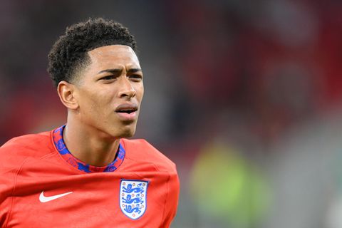 Ein farbiger Mann im roten Trikot des englischen Fußball-Nationalteams macht ein fragendes Gesicht
