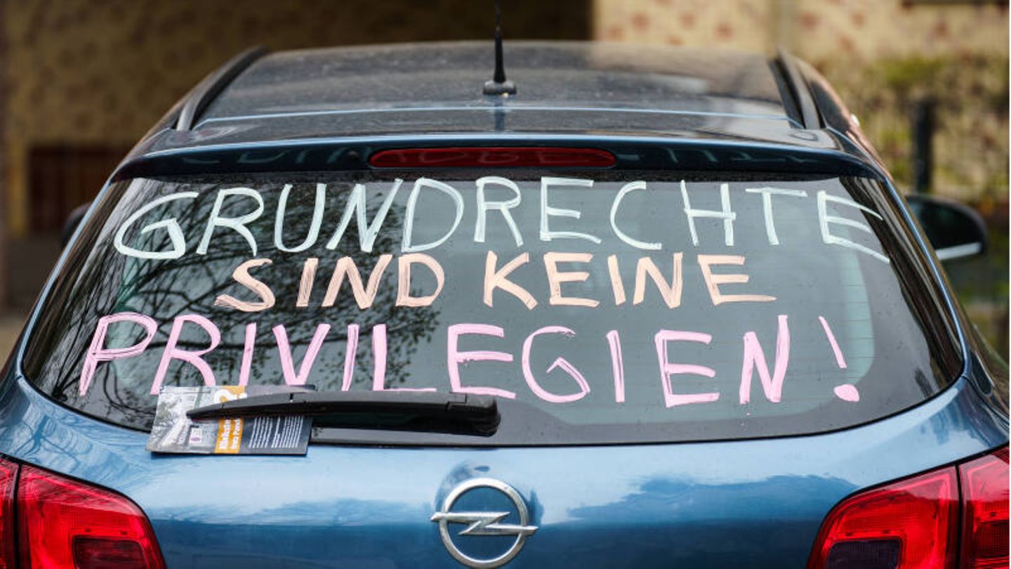 Die Heckscheibe eines PKW trägt die Parole ·Grundrechte sind keine Privilegien!·