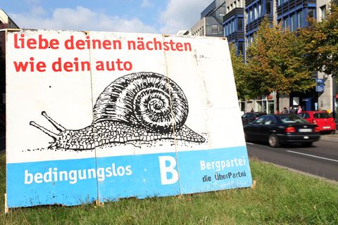 Ein Wahlplakat der Bergpartei mit dem Spruch "Liebe deinen nächsten wie dein Auto"