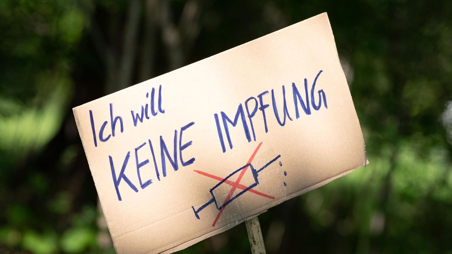 Ein Pappschild mit der Aufschrift "Ich will keine Impfung" und einer durchgestrichenen Spritze