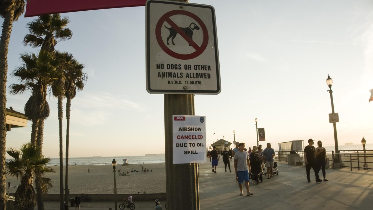 In Huntington Beach wurden Spaziergänger und Surfer angewiesen, den Strand zu verlassen. Eine für Sonntag geplante Flugshow, zu der Tausende Schaulustige am Strand erwartet worden waren, musste kurzfristig absagt werden – wie ein weiteres Schild hinweist.