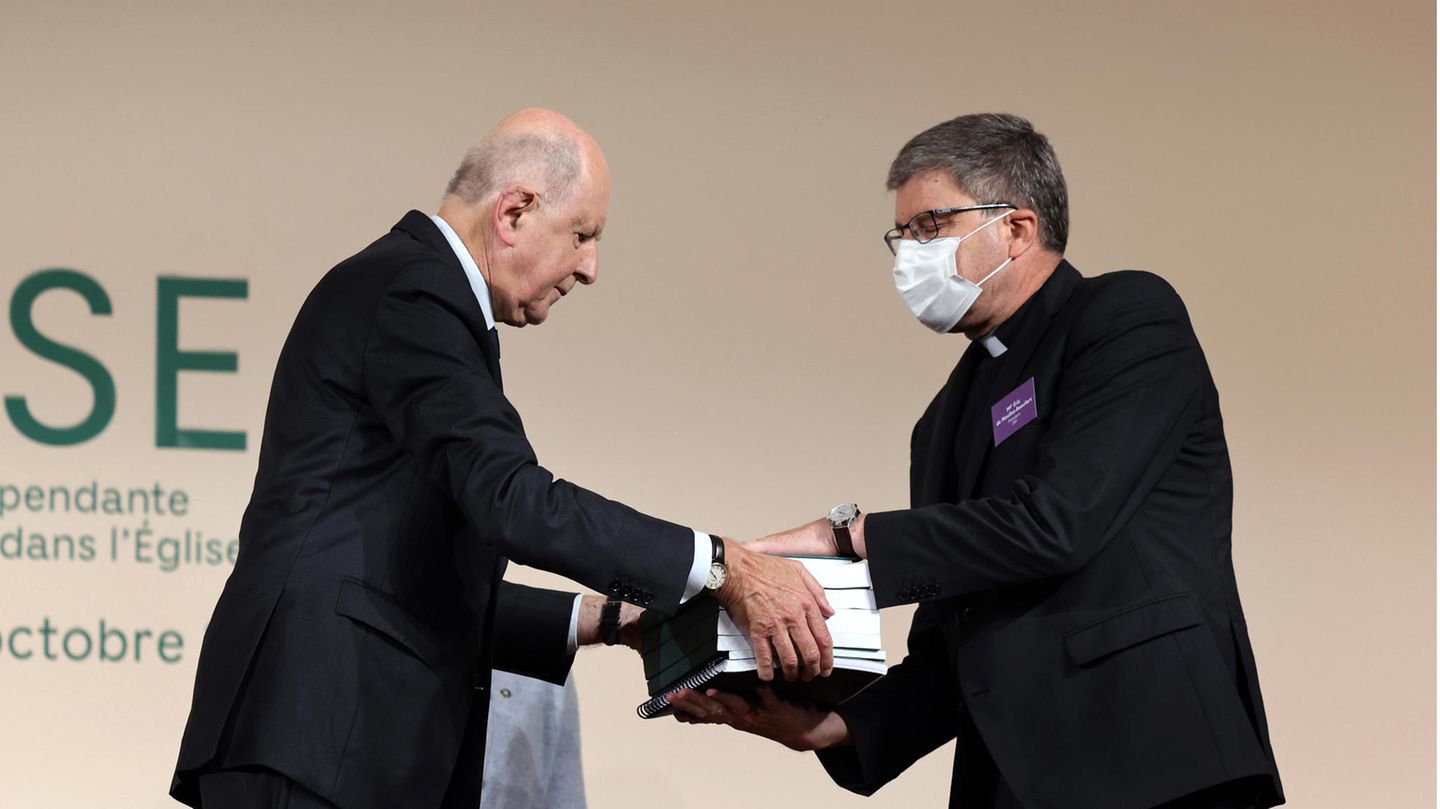 Kommissionspräsident Jean-Marc Sauve (l) übergibt Kopien des Berichts an den katholischen Bischof Eric de Moulins-Beaufort