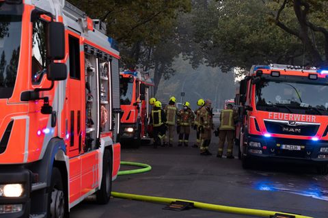 Feuerwehrleute vor Einsatzwägen