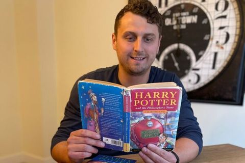 Mann namens Harry Potter hält einen Harry Potter-Roman in der Hand