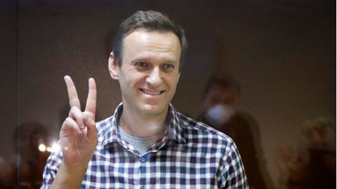 Alexej Nawalny zeigt das Peace-Zeichenr in einem Käfig im Bezirksgericht Babuskinskij