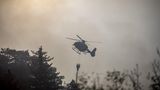 Löschhubschrauber im Feuerdunst