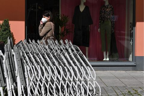 Eine Frau trägt eine FFP2-Maske vor einem Geschäft in Rosenheim (Bayern)