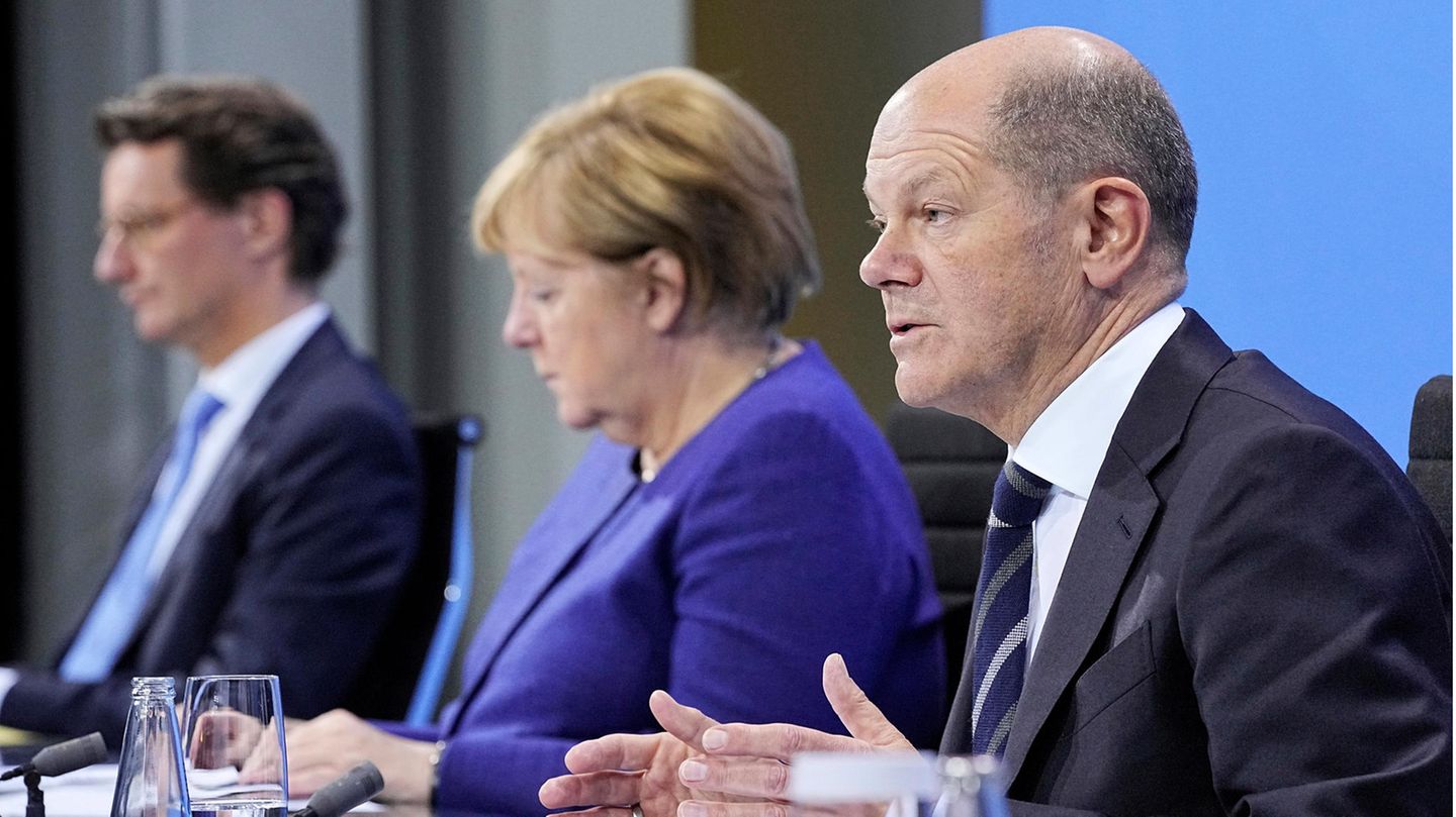 Olaf Scholz und Angela Merkel erklären die neuen Maßnahmen gegen Corona. 