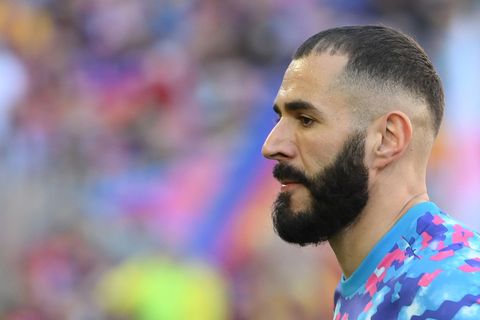 Im Profil ist eine weißer Mann mit dunklem Vollbart in einem Fußballstadion