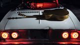 Auf einem zweiten Dezemberbild ist einfach nur eine Gitarre zu sehen, die auf dem Heck eines Autos liegt.
