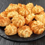 Kokosmakronen      Zutaten:  100 g Kokosraspel, ¼ TL Zimt, ¼ TL gemahlene Vanille, 1 Prise Salz, 50 g Ahornsirup (oder Honig), 25 g geschmolzenes Kokosöl      Zubereitung:  Gemahlene Koksraspel in einer beschichteten Pfanne ohne Fett etwas rösten, bis sie aromatisch duften. Zimt, Vanille und Salz hinzufügen und abkühlen lassen.  Ahornsirup und zerlassenes Kokosöl dazugeben und mit einem Kochlöffel gut verrühren. Die Masse für 10 Minuten in den Kühlschrank stellen.  Den Backofen auf 160°C Ober-/Unterhitze vorheizen. Backblech mit Backpapier auslegen.  Mit einem Löffel kleine Portionen der Masse abstechen und auf das Backblech drücken. Die Form mit einem Löffel nachbessern.  Die Kokosmakronen auf der mittleren Schiene für ca. 15 Minuten backen. Herausnehmen und vollständig auskühlen lassen. Erst nach dem Abkühlen sind sie fest, vorher sind die Makronen zu weich und brechen leicht.