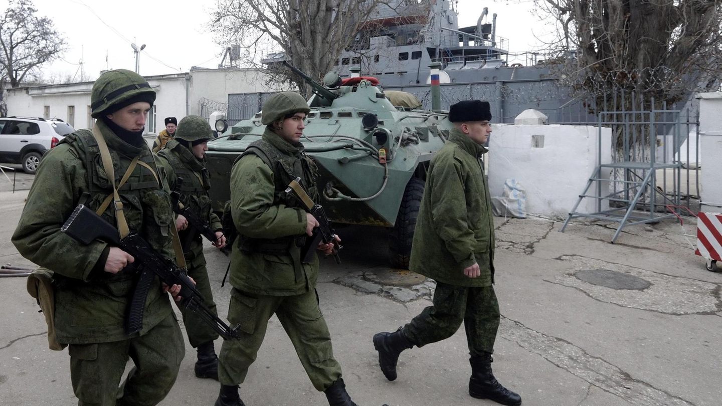 VOE STERN 52/2021 epa04106603 Russian soldiers from the Marine Infantry walk as they guard the Russian landing ship 'Orsk' (on background) anchored in the port of Sevastopol, Crimea, Ukraine, 02 March 2014. Russia ratcheted up the tension over... Soldaten der russischen Marineinfanterie im Hafen von Sewastopol auf der Krim Anfang März 2014, im Hintergrund liegt das russische Landungsschiff "Orsk"